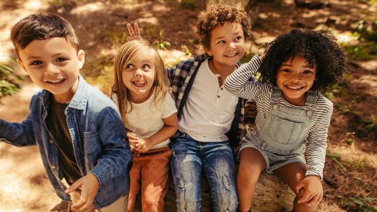 young kids smiling outisde